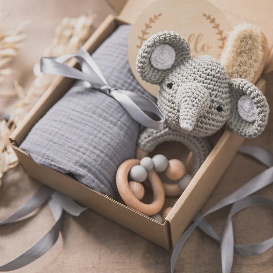 Cuddovia newborn gift set with swaddle blanket and wooden teether